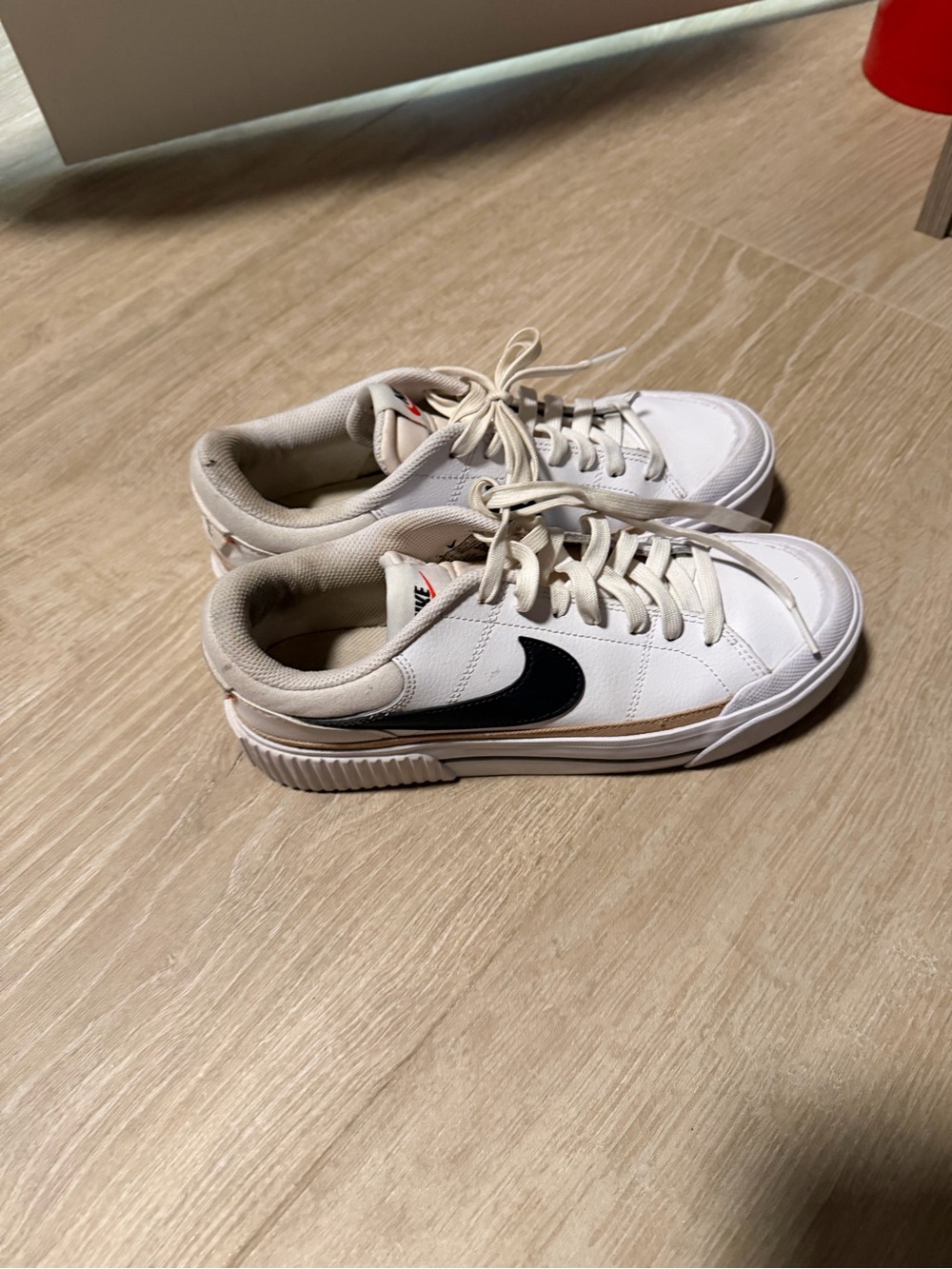 Nike Women's White Sneakers with Black Swoosh and Tan Accent